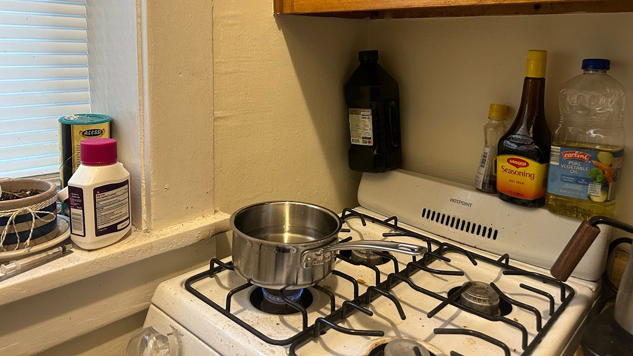 pot of water sitting on lit gas stove