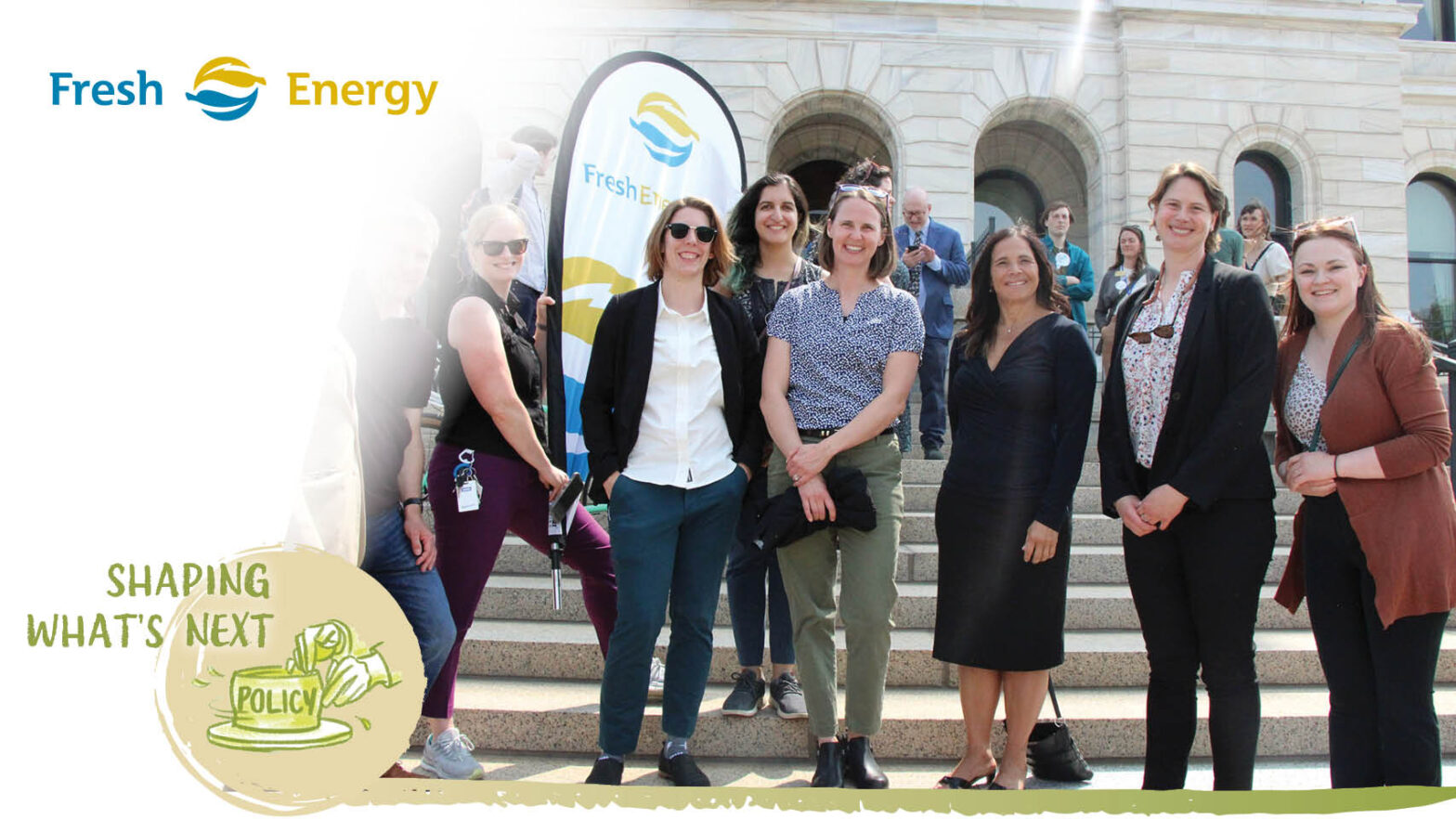Fresh Energy Staff standing on the steps of the Capital. Text" Shaping What's Next