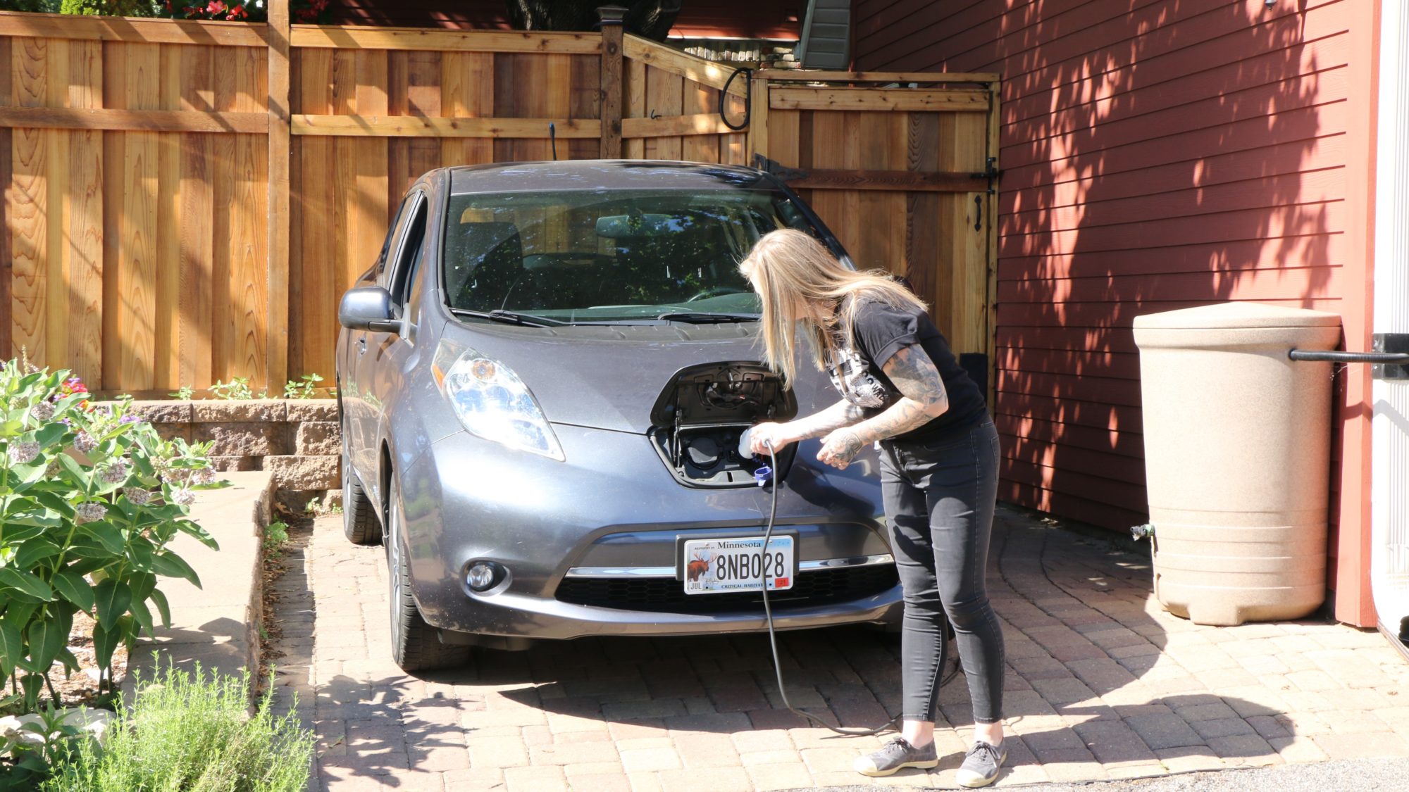 Person plugging in their electric vehicle.