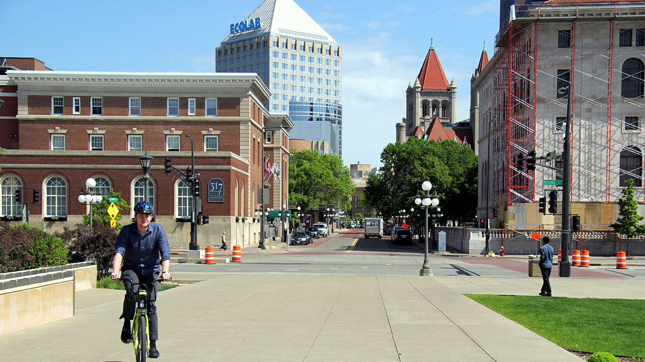 Man riding bicycle in downtown Saint Paul.