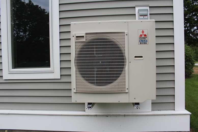A ductless heat pump installed outside of a home in Maine.