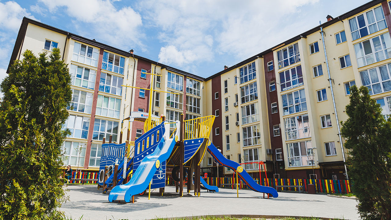 Children's playground in the courtyard of a residential building.