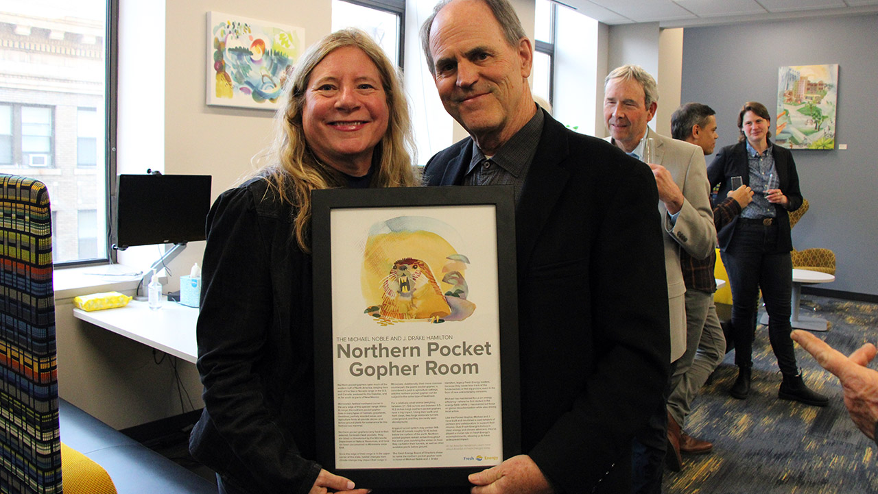 J. Drake Hamilton and Michael Noble hold framed art of a Northern Pocket Gopher.