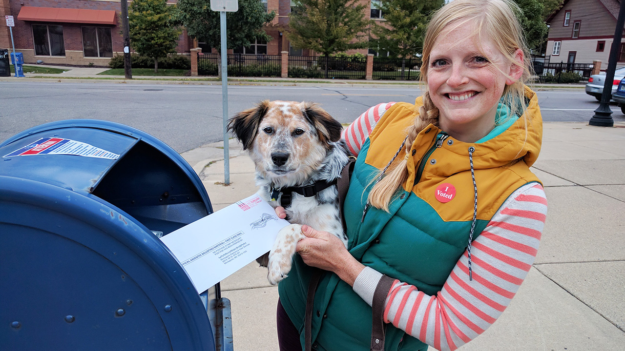 Fresh Energy's communications director Jo and her dog tubby mailing in her ballot