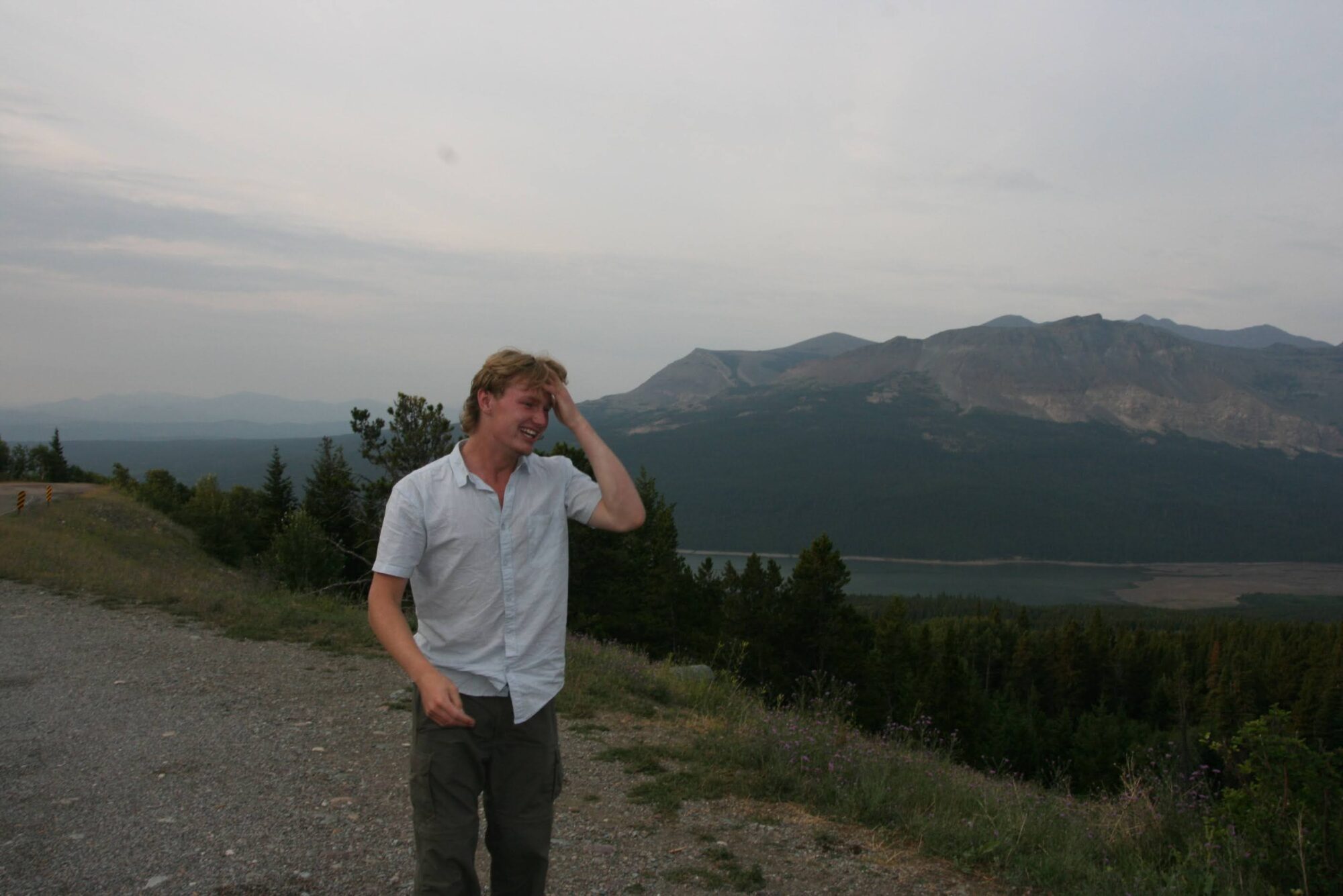 Chaz posing in front of a mountain near a lake. 